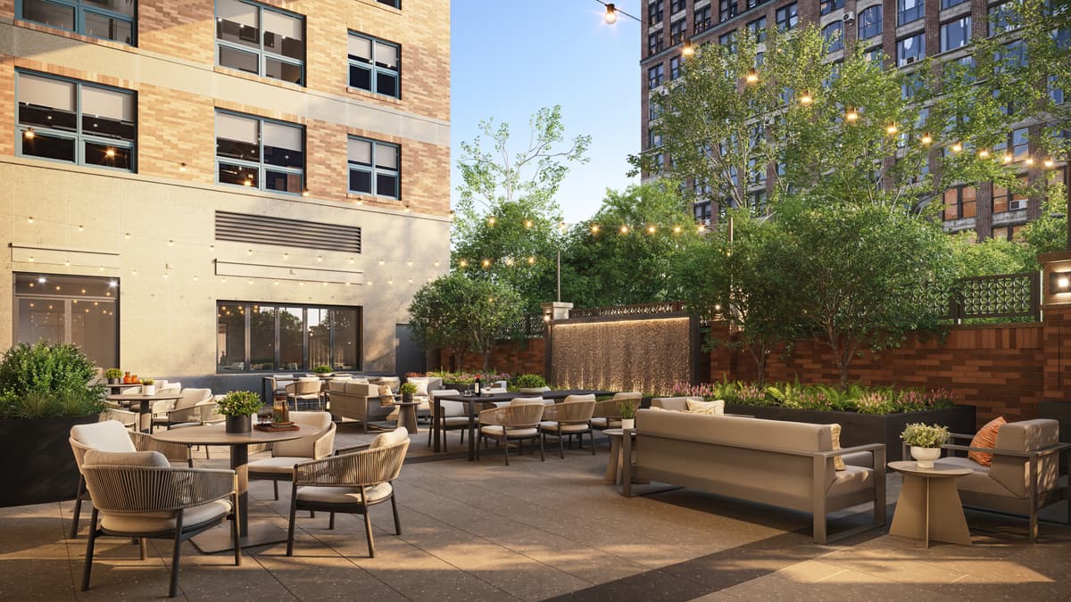 Evening rendering of a furnished amenity courtyard with string lights between residential towers